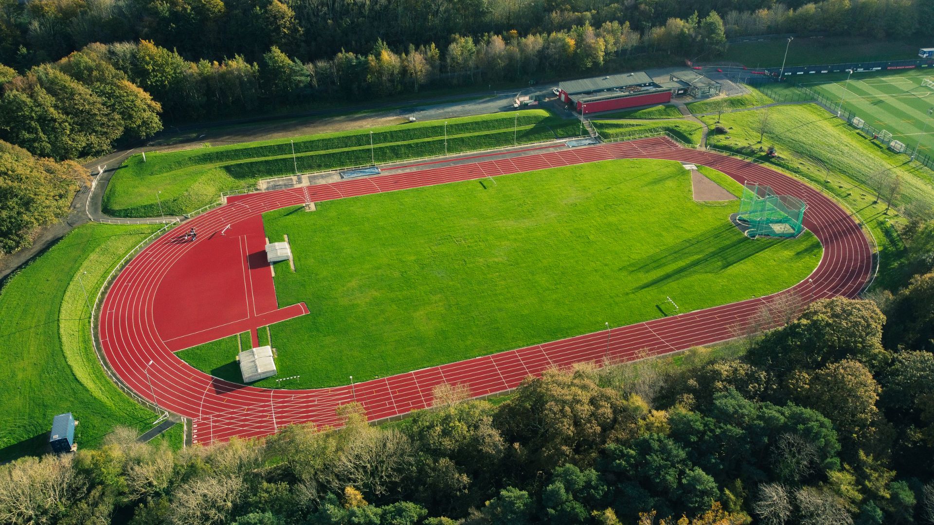 Aerial view of a vibrant track and field, showcasing running tracks