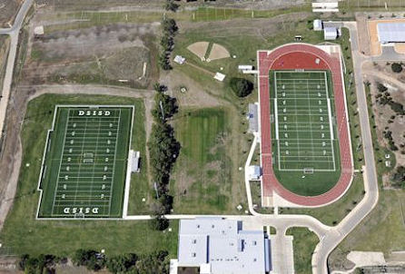 Overhead perspective of a football field and stadium