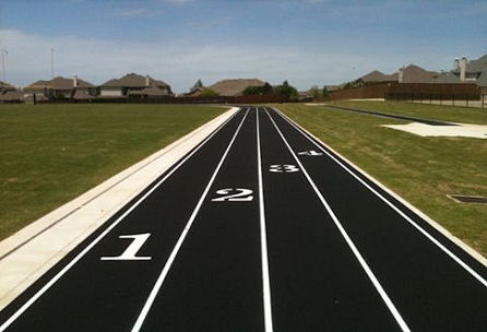 A close-up view of a running track featuring numbered lanes